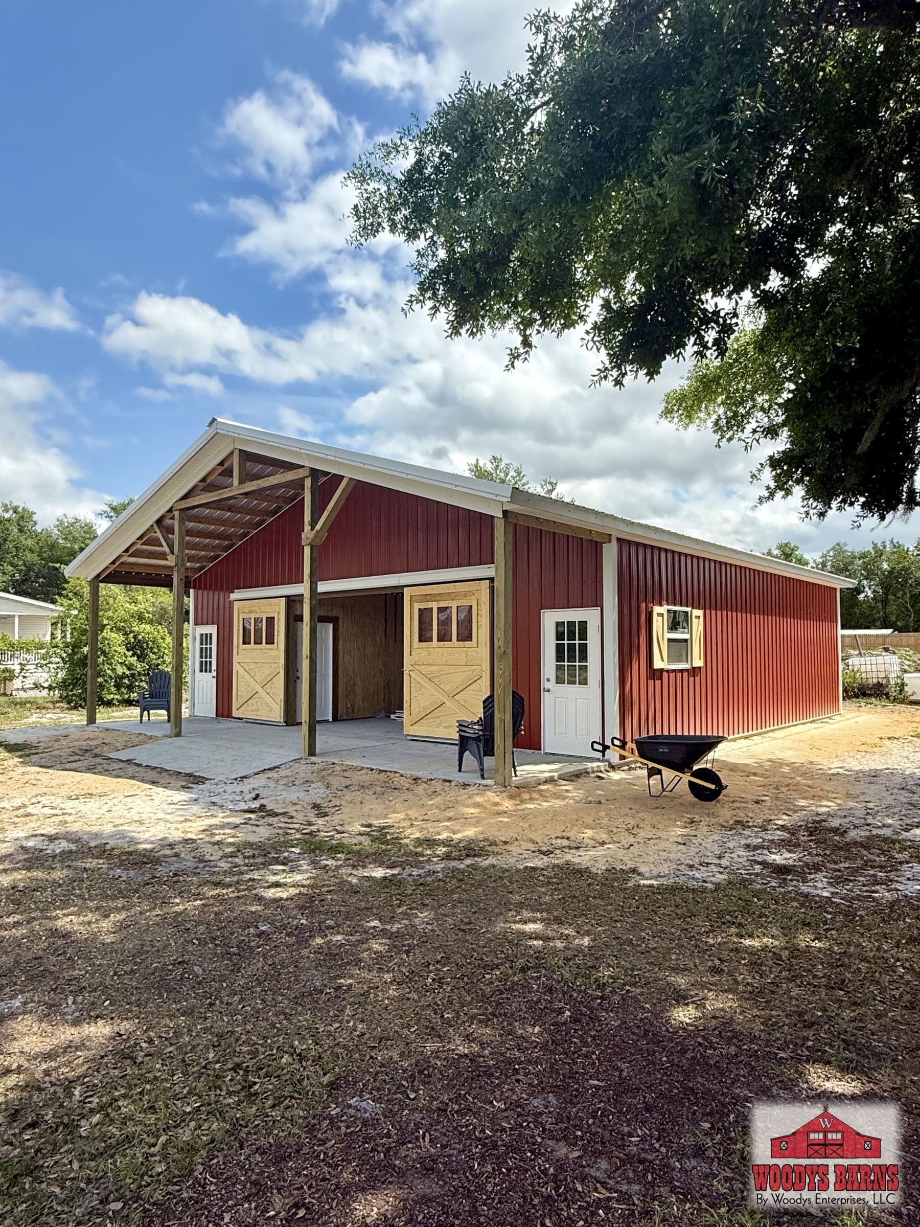 The Bender building, barn red with a covered porch under live oaks